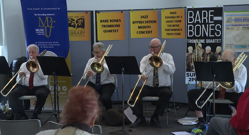 Trombone Quartet performing in concert. 